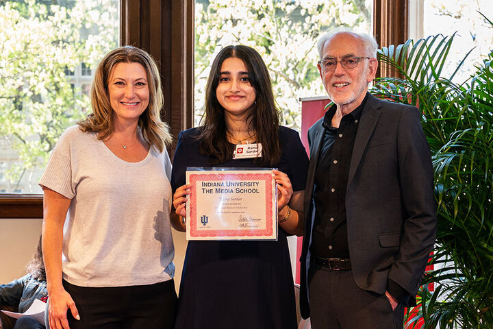 A student receives a scholarship from The Media School.